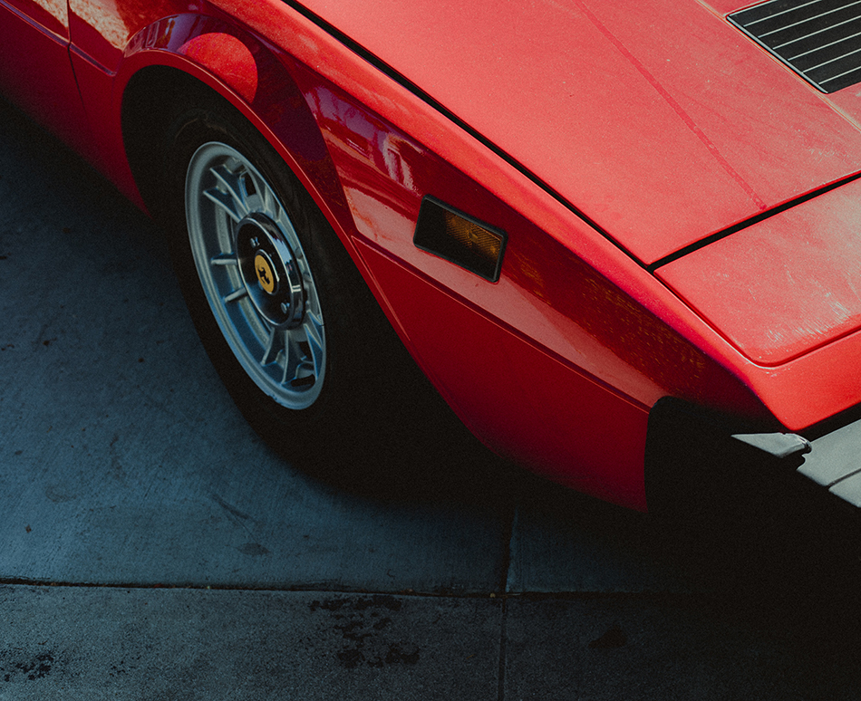the corner of a vintage ferrari