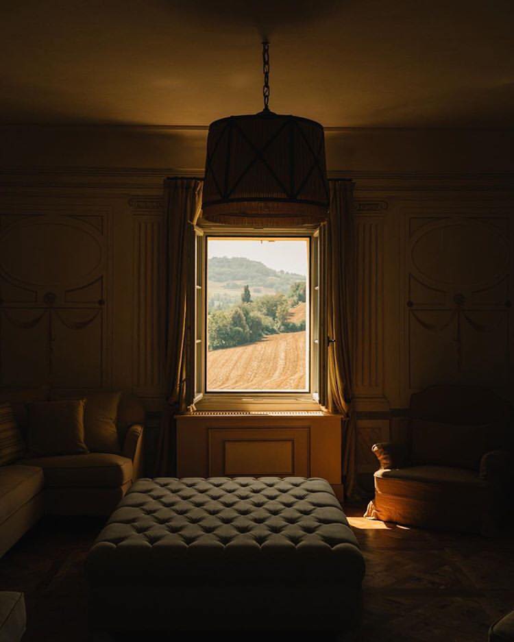 A picturesque view of the Italian countryside from inside a villa